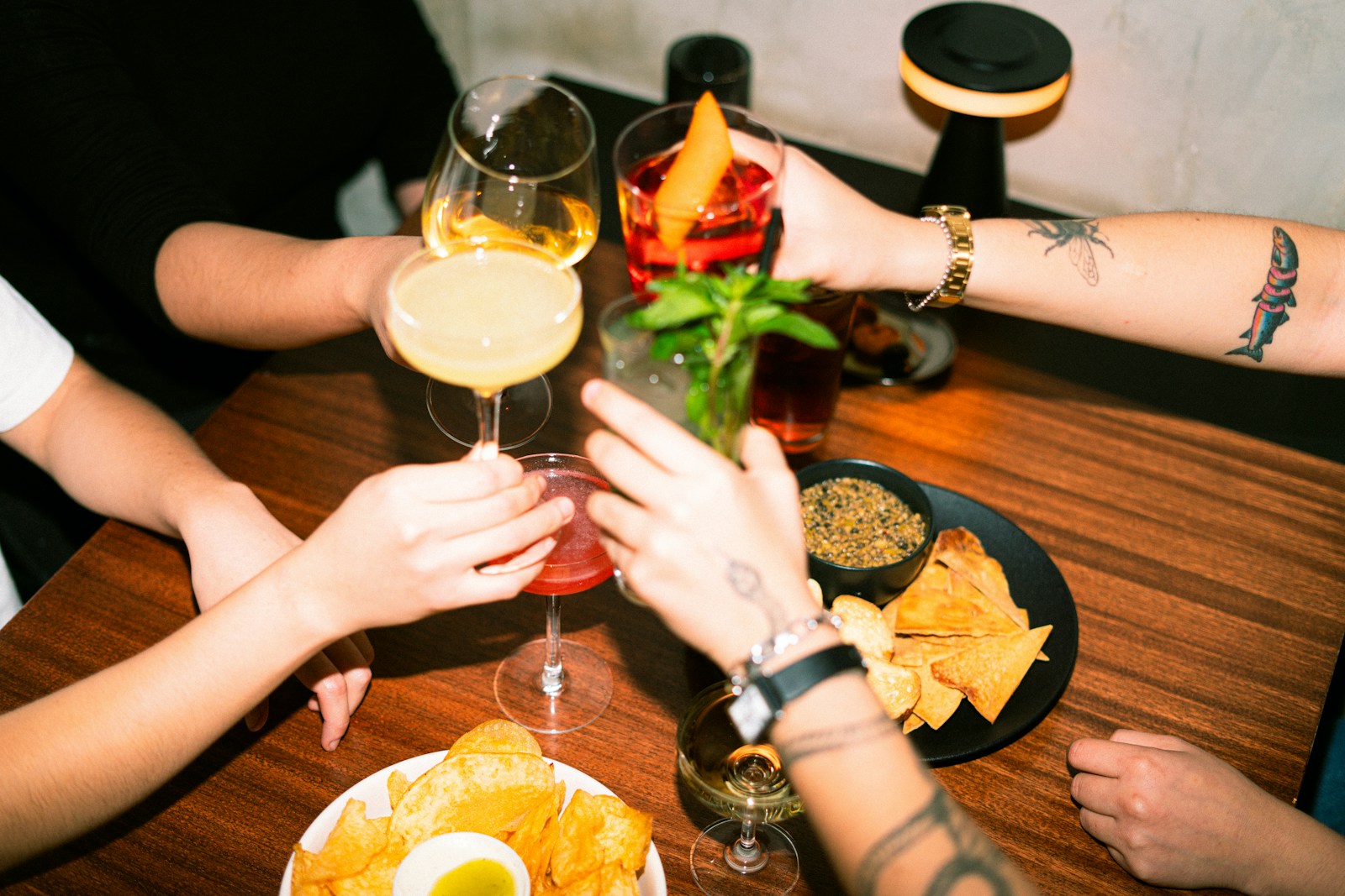 Friends toasting with cocktails at an elegant gathering